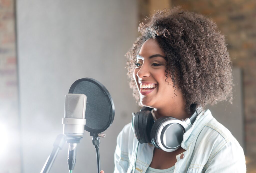 Happy voice-over artist at recording studio