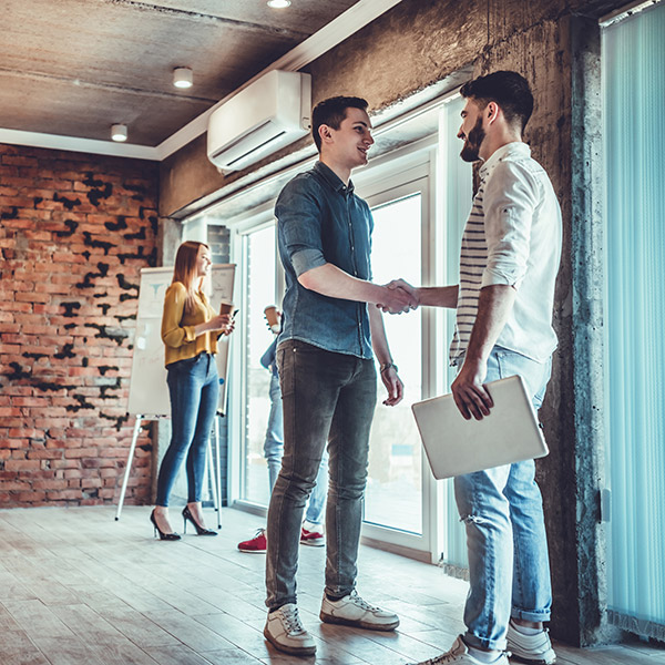 Two translation partners shaking hands at a voice-over agency