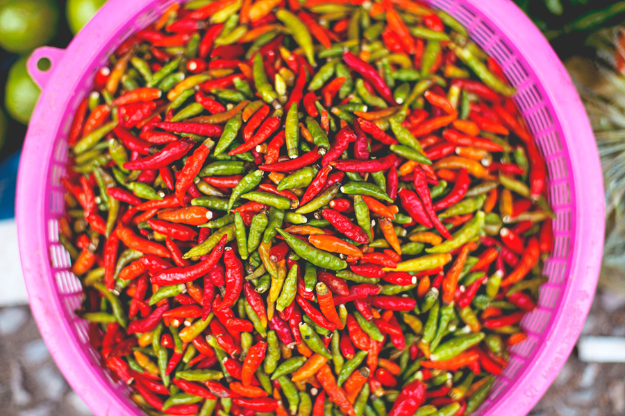 colourful Mexican chillies in purple basket