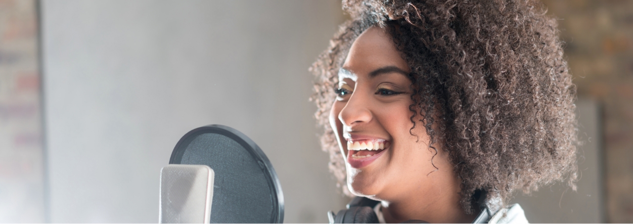 female voice-over artist at microphone