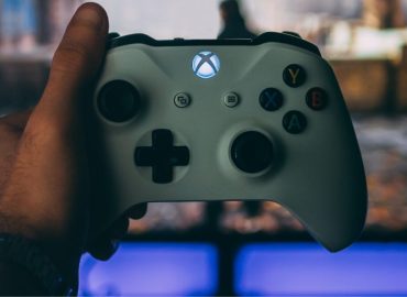 an image of a man holding an xbox controller