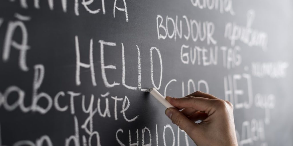 person holding a chalk and writing on a blackboard
